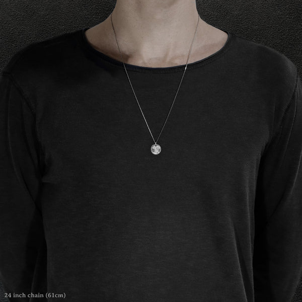 Model wearing Platinum 950 Journey pendant and chain with endless loop necklace featuring the Map of Humanity as outward journey by Caps Brothers